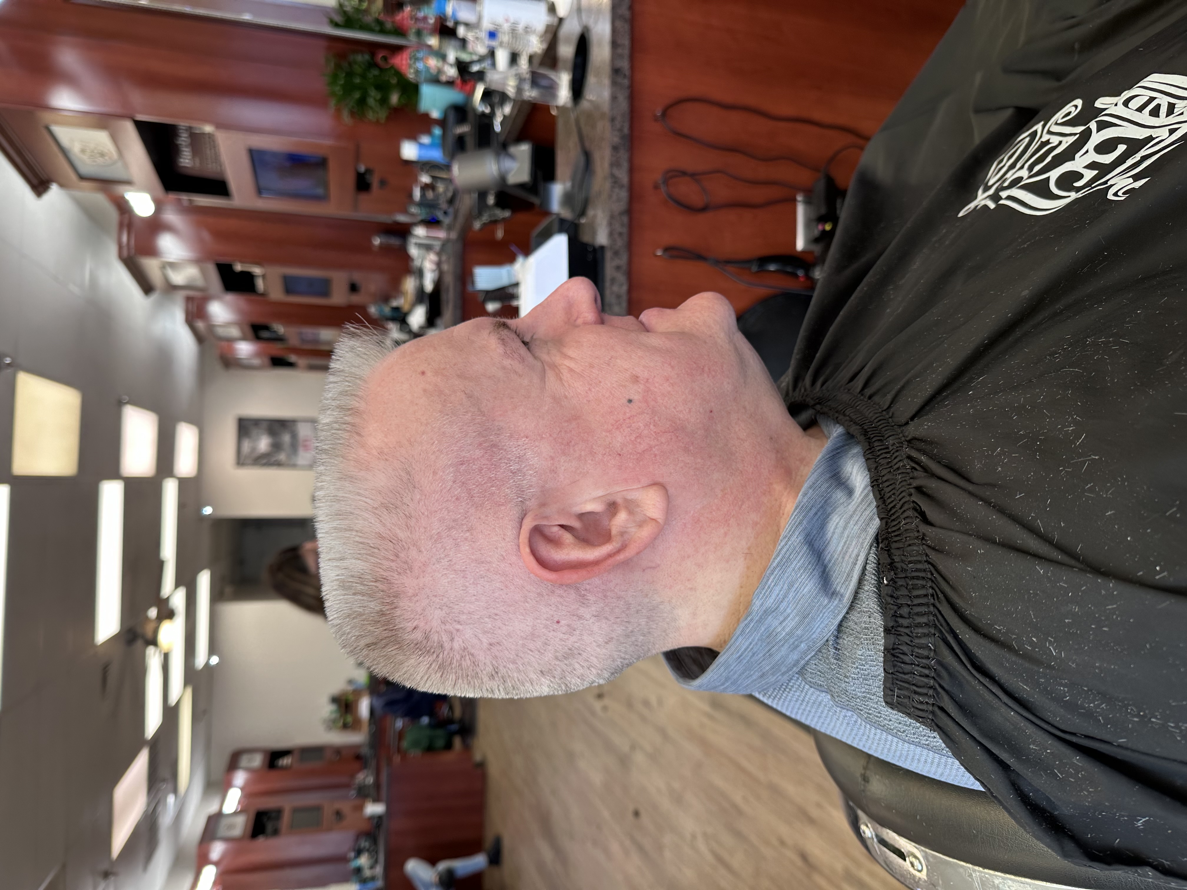 man in barbers chair getting hair cut