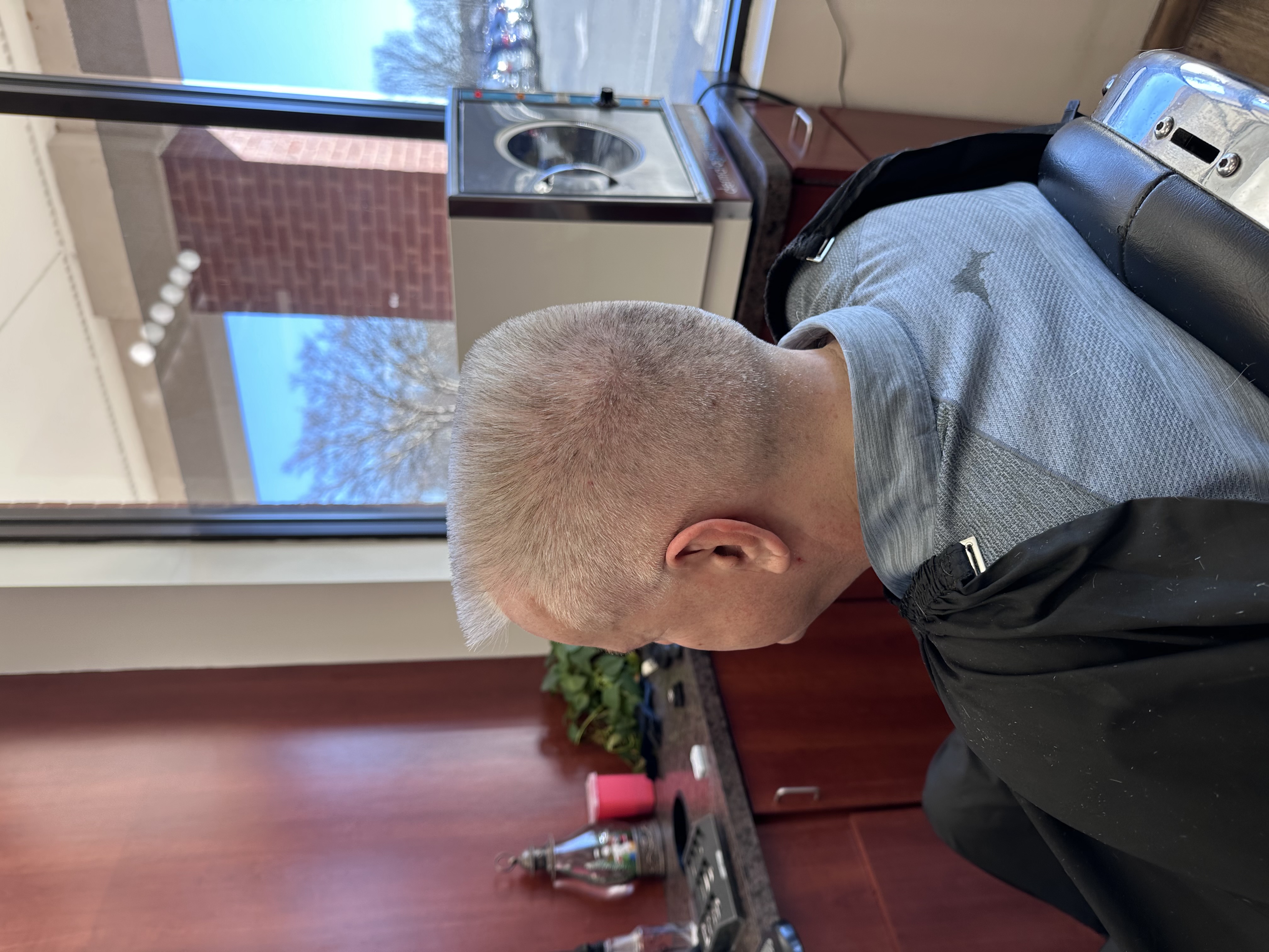 man in barbers chair getting hair cut