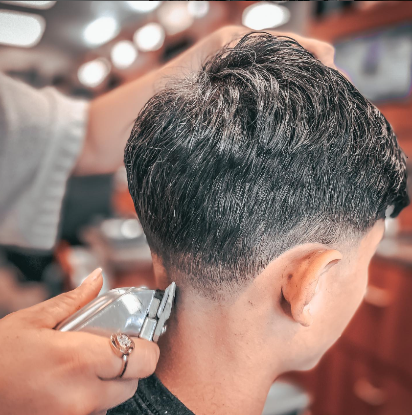 man in barbers chair getting hair cut