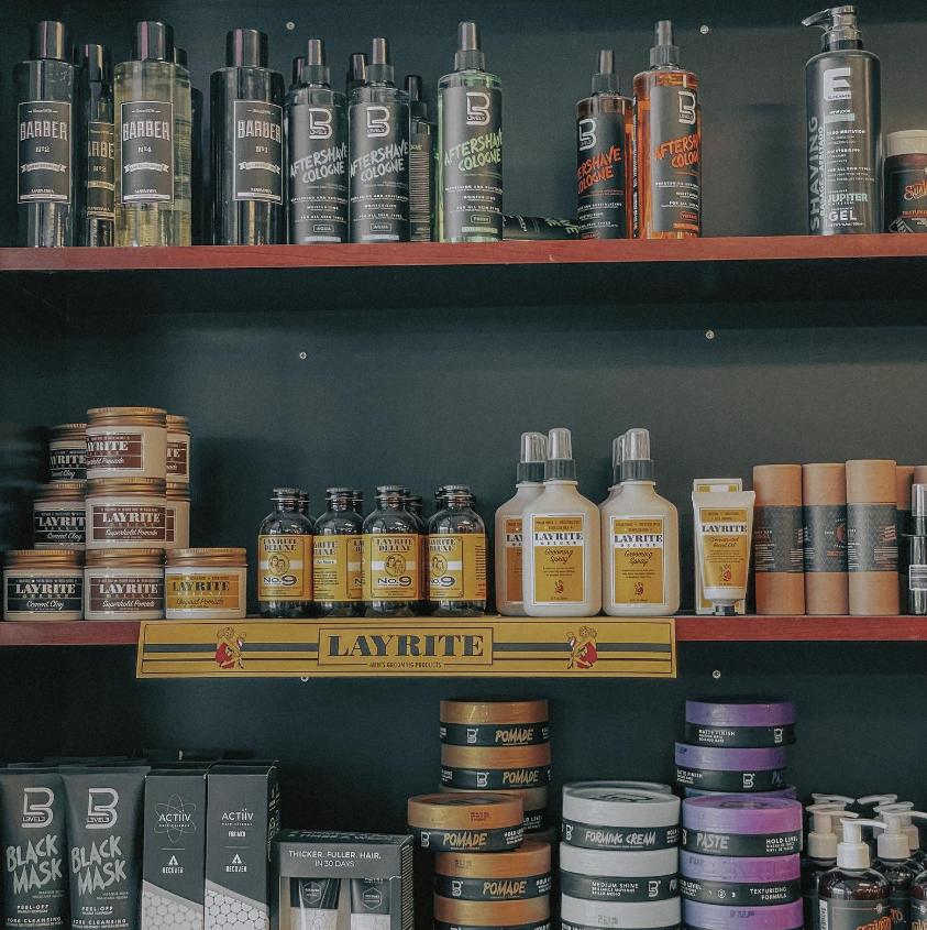 hair care items on shelf inside barbershop